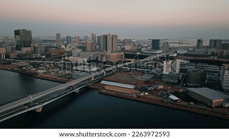 Modern urban waterfront city aerial twilight view. Drone point of view.