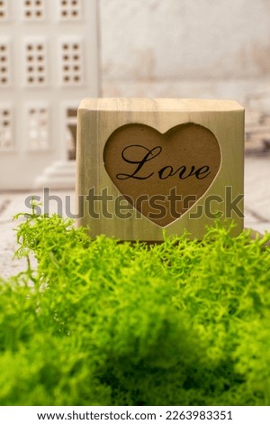 a box with the word love.background with a box and houses.love