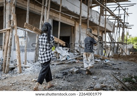 Children working at construction site for world day against child labor concept: Royalty-Free Stock Photo #2264001979