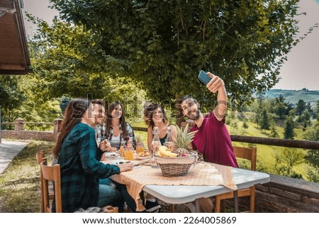 Happy cheerful  group of friends having breakfast in a farmhouse - Young people eating in the garden, concepts about healthy lifestyle and food