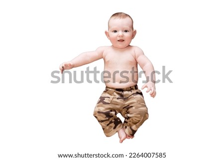 A funny happy baby boy is lying in a military uniform. Smiling child with a bare tummy in khaki clothes, isolated on a white background