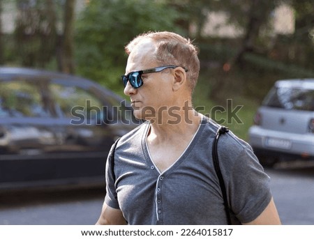 attractive middle aged man walking in the park