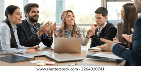 Diverse business people welcoming new employee to their team. Happy friendly business colleagues congratulating to their new coworker. Royalty-Free Stock Photo #2264020741