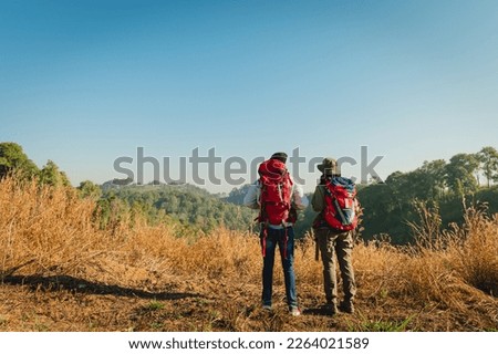 traveler couple with backpack standing looking view on mountain