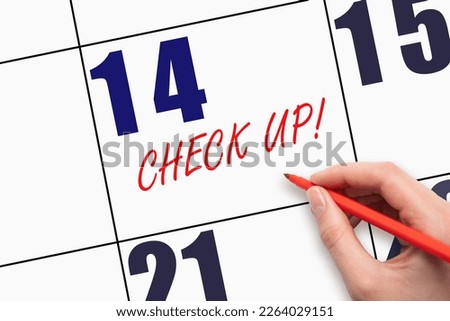 14th day of the month.  Hand writing text CHECK UP on calendar date. Doctor Healthcare Medical Schedule Appointment Concept. Doctor date at calendar. Day of the year concept.