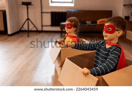 Superhero children. Super hero kids, brother and sister, playing at home. Moving, sucsses and joyful play concept