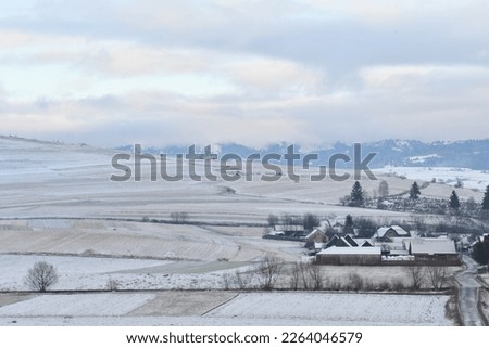 Winter landscape with a village in the background