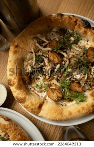 neapolitan pizza with burnt edges close up top view. vegetarian pizza with potatoes and onions.