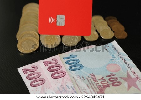 Paper banknote, turkish iron coins and credit card on black background. 100 and 200 pounds. economy and finance.