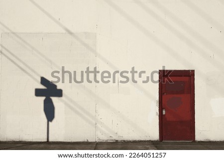 Abstract cityscape with red door and shadows