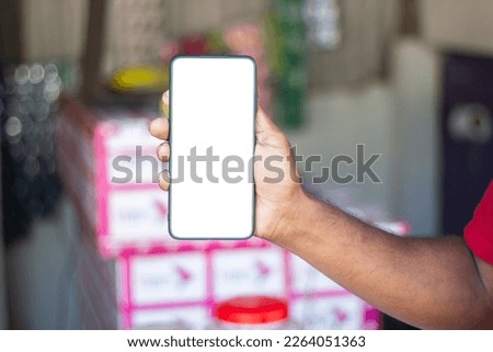 a man show his own mobile phone and the background is blurred