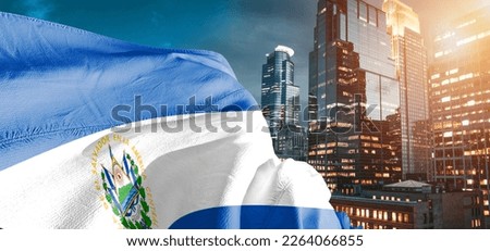 El Salvador national flag cloth fabric waving on beautiful blue sky.