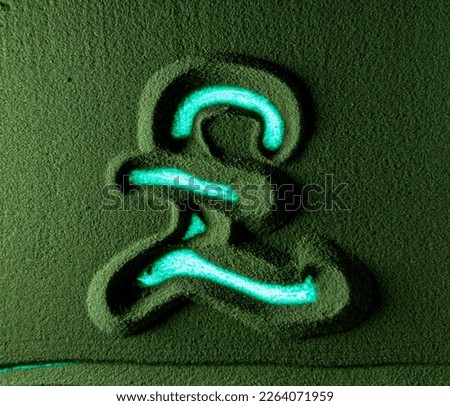 Hand drawing the Pound currency symbol in the Green Sand. Male hand writes the Pound currency symbol on the green sand with blue backlight. Top view 4k resolution