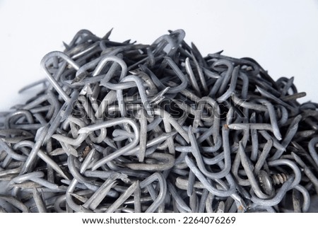 pile of heavy barbed wire staples for construction and carpentry Royalty-Free Stock Photo #2264076269