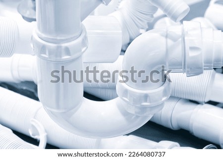 Plumbing sanitary white plastic sewer pipes siphons overflows for bathroom and sink. Royalty-Free Stock Photo #2264080737