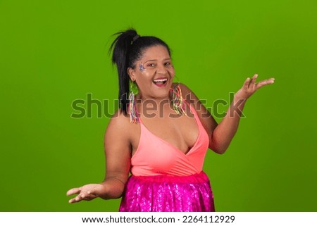 Young beautiful woman wearing carnival costume over isolated green background surprised and pointing to the side