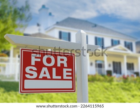For Sale Real Estate Sign in Front of New House.