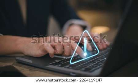 Businesswomen using computer laptop or tablet with triangle caution warning sign for notification error and maintenance concept.