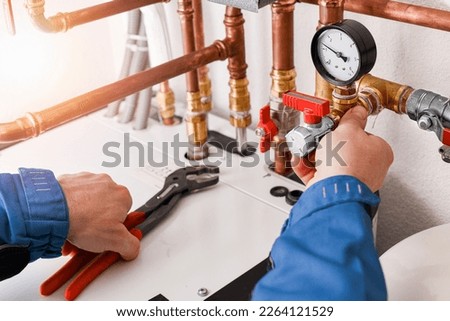 Plumbing concept or service water worker. copper pipeline of a heating system in technical room. Boiler and expansion expansion tank system, detail of pressure gauge. Royalty-Free Stock Photo #2264121529
