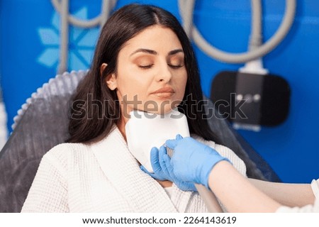 coolsculpting procedure in cosmetology clinic, cosmetologist doctor makes procedure for removing fat from the chin to patient Royalty-Free Stock Photo #2264143619