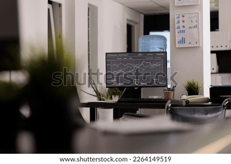 Close up of an empty desk with no people in disabled friendly office, computer and modern equipment, shelving with files in a business space. Workplace with technology and working tools at daytime.