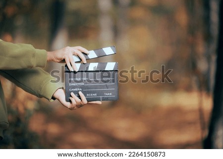 
Director Holding a Cinema Slate in Outdoors Set. Independent filmmaker using natural light and resources to produce videos
 Royalty-Free Stock Photo #2264150873