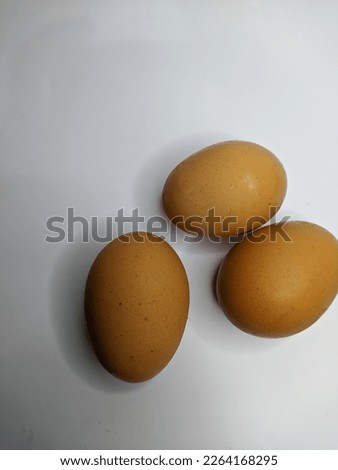three chicken eggs with brown shell isolated on white background