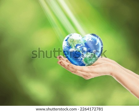 Earth in heart shape in hands in green blackground, Make Every Day as Love Earth Day concept, Elements of this image furnished by NASA