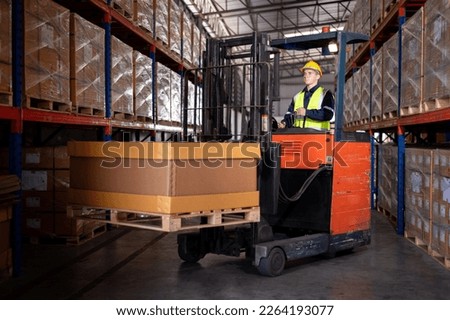 Worker industry factory wear safety uniform factory drive forklift truck moving goods boxes to industry production in factory warehouse area is industry manufacturing business concept. 