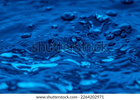 water drop splash in blue glass