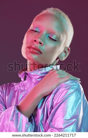 Holographic fashion, woman face and makeup glow for hologram trend isolated in studio. Futuristic, vaporwave and art color jacket on cyberpunk aesthetic model person for retro cosmetics shine on skin Royalty-Free Stock Photo #2264211717