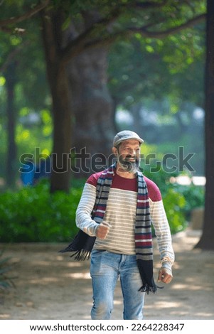 Indian man giving expression at park.
