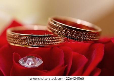 Gold wedding rings on a bouquet of flowers for the bride 
