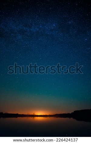 Smooth surface of the lake on a background the starry sky 