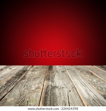 red wall in interior with wooden old table 