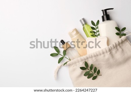 Preparation for spa. Compact toiletry bag, twigs and cosmetic products on white background, flat lay. Space for text Royalty-Free Stock Photo #2264247227