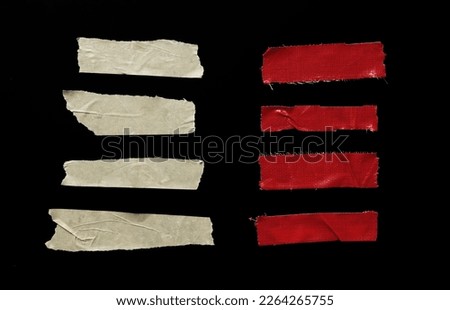 Set of pieces of general purpose yellow and red tape isolated on black Royalty-Free Stock Photo #2264265755