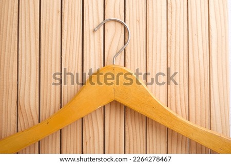 Wooden hanger for clothes on a white background wooden wardrobe