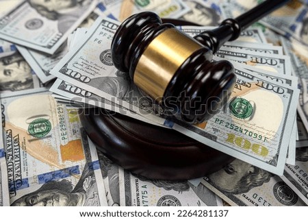 large amount of dollar money and a judge's gavel on the table isolated. Trial and bribery. corruption in higher authorities Royalty-Free Stock Photo #2264281137