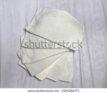 several pieces of white towels arranged in a circle stacked on top