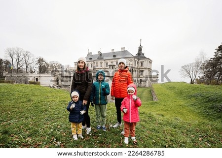 Mother with four kids visit Pidhirtsi Castle, Lviv region, Ukraine. Family tourist. 