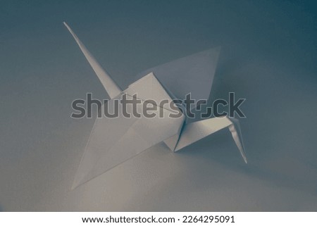 White paper crane origami isolated on a blank background.