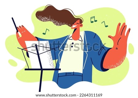 Happy woman conductor controls orchestra with stick standing near rack with notes enjoys instrumental music. Girl participates in concert as orchestra conductor on stage of opera house during tour  Royalty-Free Stock Photo #2264311169
