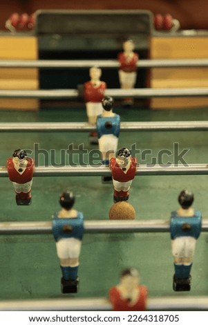 Table football, commonly called fuzboll or foosball (as in the German Fußball "football") and sometimes table soccer, is a table-top game that is loosely based on association football. Royalty-Free Stock Photo #2264318705