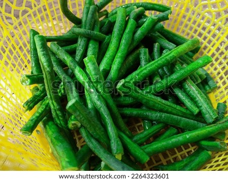 long beans in a plastic container