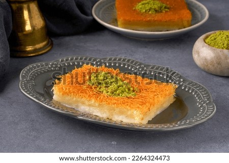 Middle eastern sweets kunefe, kunafa, kadayif with pistachio powder  Turkish , arabic traditional dessert.                      Royalty-Free Stock Photo #2264324473