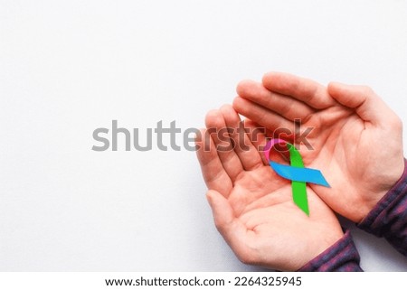 man holding a symbol of World AIDS Day Royalty-Free Stock Photo #2264325945