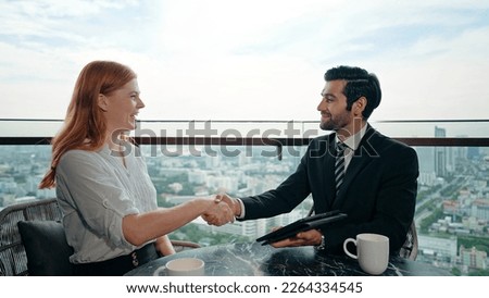 Young businessman and woman handshake for finishing successful meeting. Happy to do business together at the office building