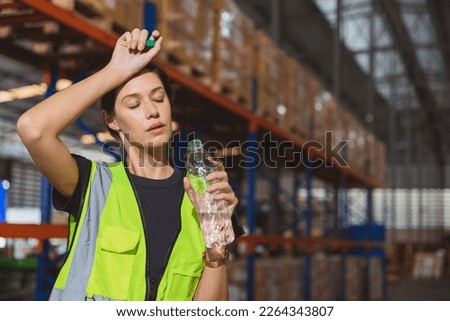 Tired stress woman staff worker sweat from hot weather in summer working in warehouse goods cargo shipping logistics industry. Royalty-Free Stock Photo #2264343807
