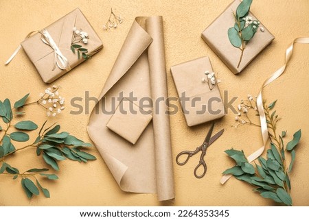 Composition with gift boxes, wrapping paper, gypsophila flowers and eucalyptus branches on color background. Women's Day celebration Royalty-Free Stock Photo #2264353345